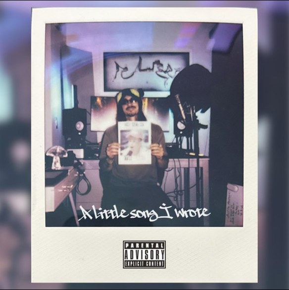 A Little Song I Wrote single artwork: a Polaroid of Sunny in his home studio holding up a photo, with the title handwritten across the bottom